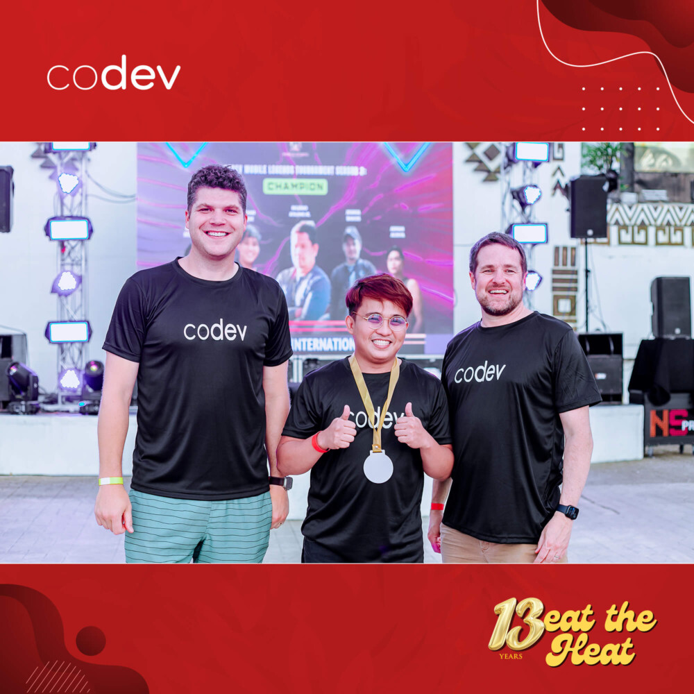 Jamie Elgie and Taylor Murphy gives recognition to CoDev employee.